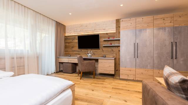 Hotelzimmer mit Holzinterieur im Alpin Resort Stubaier Hof